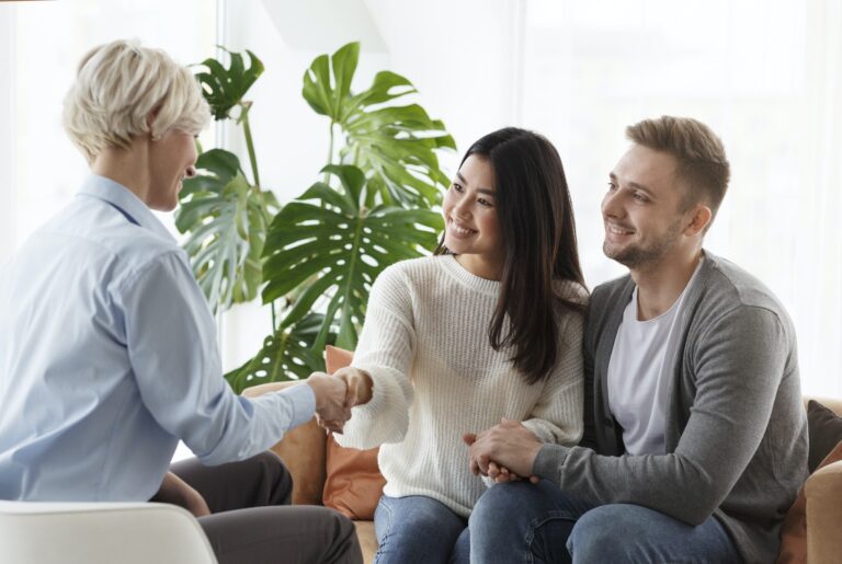 couple shaking hands with counselor thankful for help in office Intensive Outpatient Program (IOP) in California